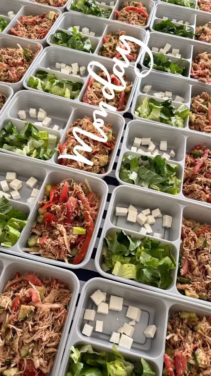 Shredded chicken salad trays with romaine, tomato, and cheese