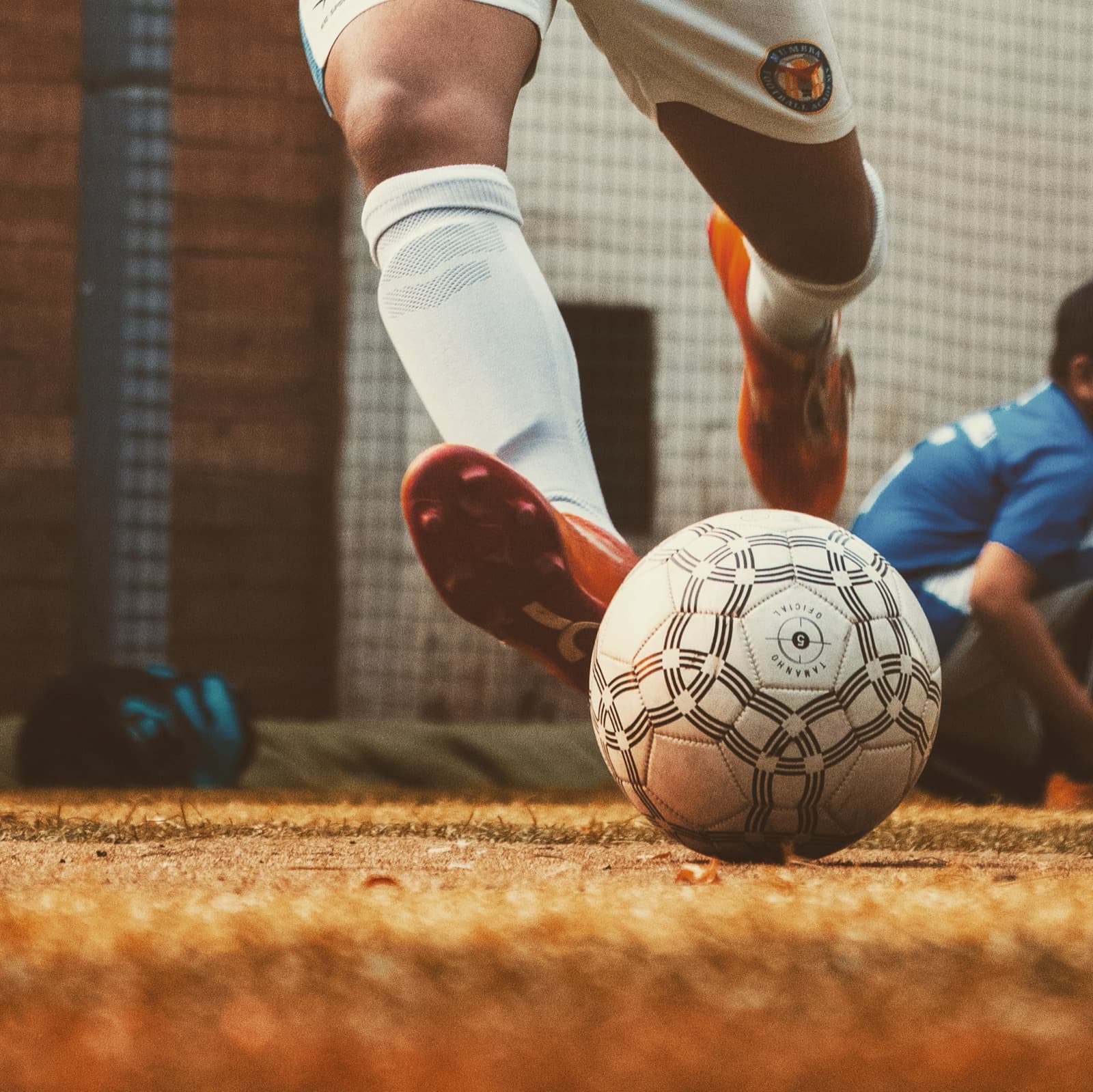 A soccer player striking the ball during training