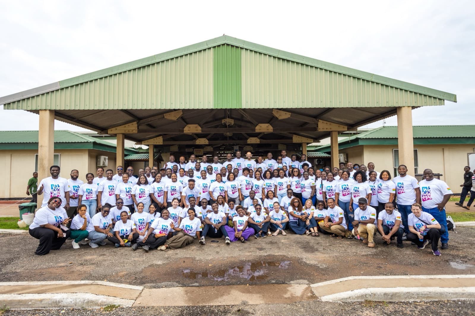 A large group of volunteers gathered together at a service mission site